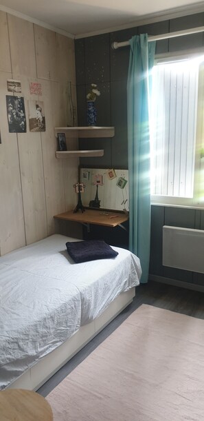 A room with a bed, a desk, and a window with curtains. - House with a pool, pool table, foosball table, and ping-pong table. (Villemur-sur-Tarn)