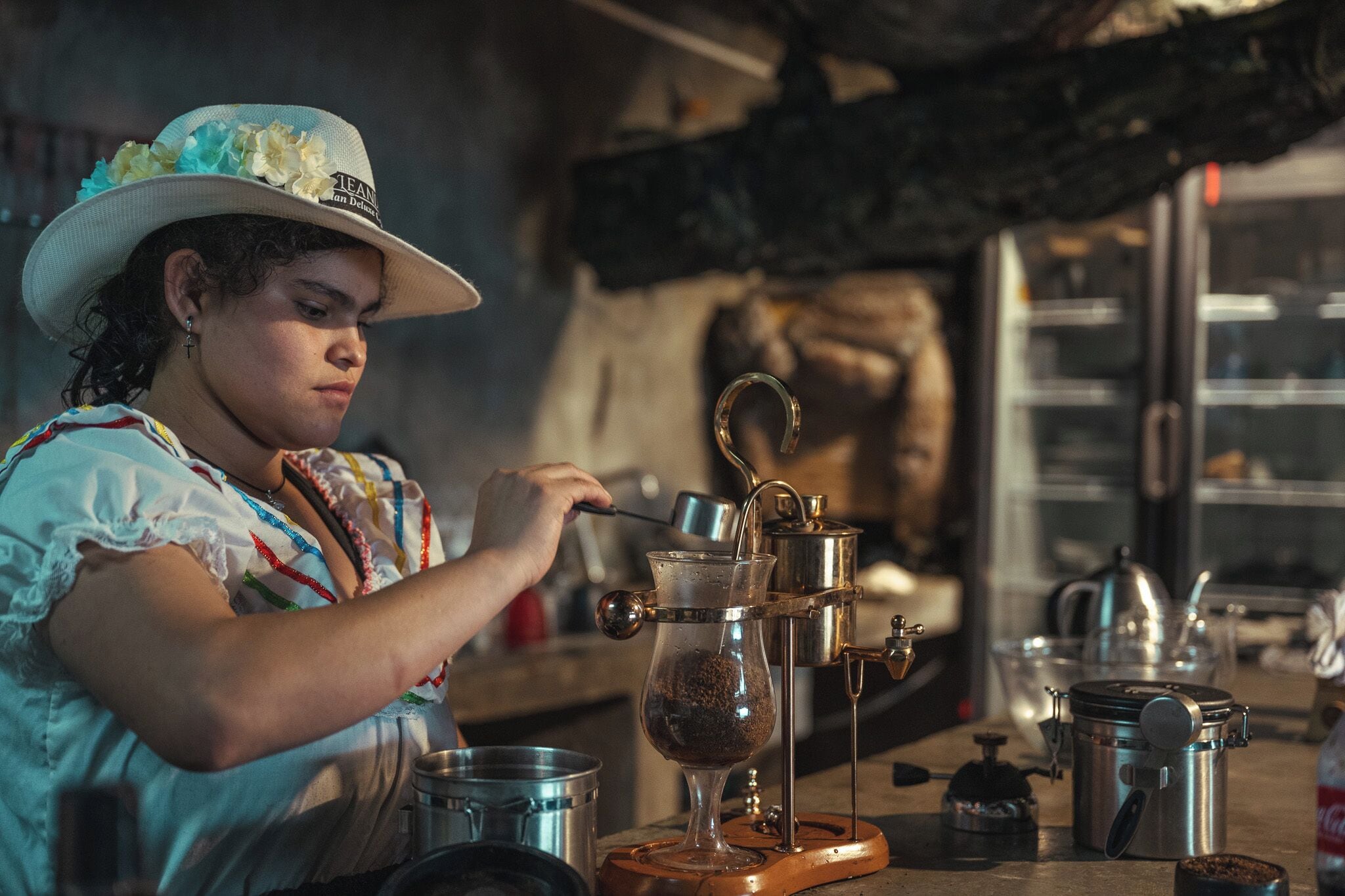 A person operating a coffee brewing device.
