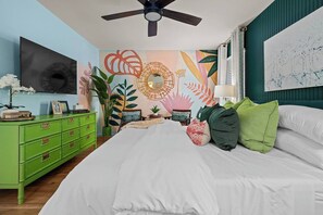 A bedroom with a bed, green dresser, and a ceiling fan. - NEW! Pool, HotTub, Pickleball, Mini Golf + Theater (San Antonio)