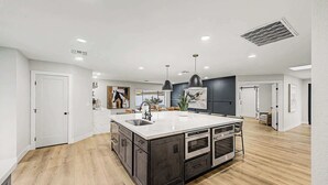 A spacious kitchen with a large island, modern appliances, and pendant lighting. - NEW| The Fairmont @ Kierland | Pool, Spa & Daybeds (Scottsdale)