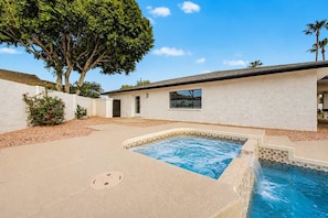 A residential property with a swimming pool, a white exterior wall, and a large tree. - NEW| The Fairmont @ Kierland | Pool, Spa & Daybeds (Scottsdale)