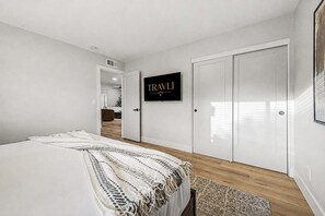 A bedroom with a bed, a TV mounted on the wall, and a wardrobe. - NEW| The Fairmont @ Kierland | Pool, Spa & Daybeds (Scottsdale)