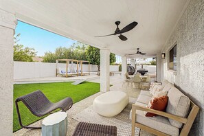 An outdoor patio with a covered seating area, a grill, and a pool. - NEW| The Fairmont @ Kierland | Pool, Spa & Daybeds (Scottsdale)