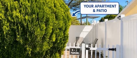 A gated entrance with a sign indicating 'No Parking' and directional arrows to 'Your Apartment & Patio' and 'Entrance'.