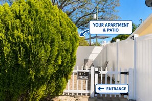 A gated entrance with a sign indicating 'No Parking' and directional arrows to 'Your Apartment & Patio' and 'Entrance'. - 1BR Studio Best Location, Siesta Key, 8mins, 2 People (Sarasota)