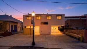 A building with a sign reading 'HOFF & CO FLATS' at dusk. - Iron Horse at Hoff & Co | Off 4th Ave (Tucson)