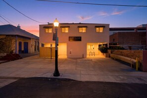 A building with a sign reading 'HOFF & CO FLATS' at dusk. - Iron Horse at Hoff & Co | Off 4th Ave (Tucson)
