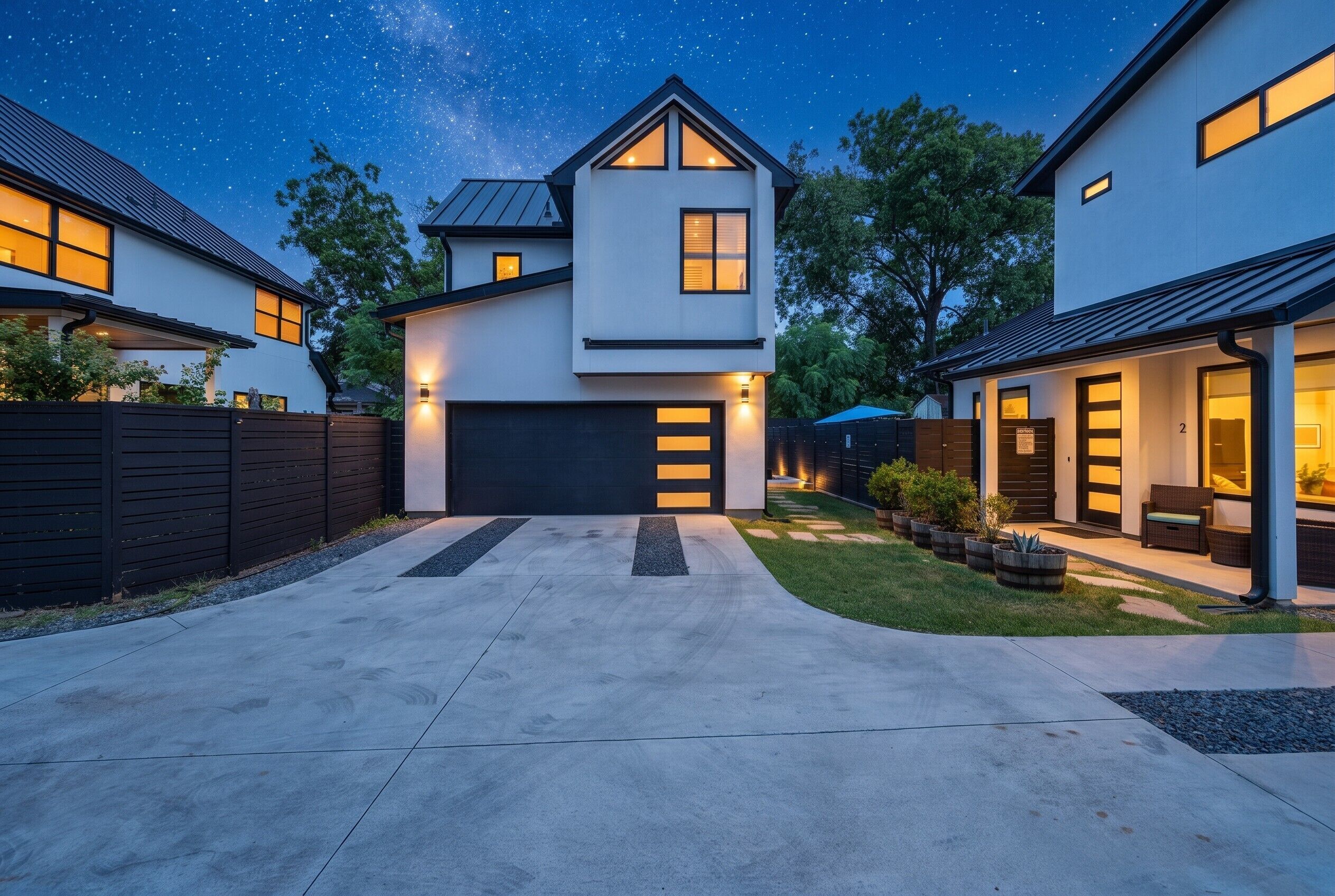 A modern two-story house with a garage, a driveway, and a well-maintained lawn.