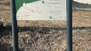 A sign with a map and text, likely providing information about a location.