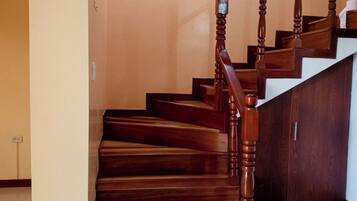 A wooden staircase with a handrail and a landing.