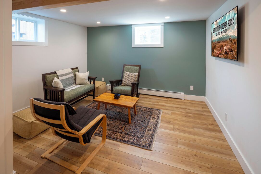 A living room with a sofa, armchair, and a coffee table.