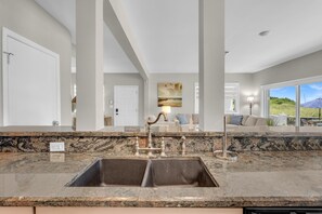 A modern kitchen with a granite countertop, a double sink, and a stainless steel faucet. - Pompano Beach + Townhouse + Private Beach + 3 bedroom + Pool = PERFECTION! (Pompano Beach)