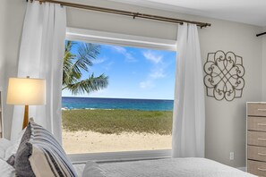 Une chambre avec vue sur la plage, une lampe et un élément décoratif mural.