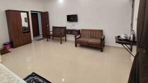 A modern living room with a sofa, a wooden coffee table, and a TV mounted on the wall.