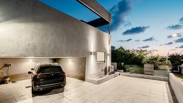 A modern building with a car parked in an outdoor area.