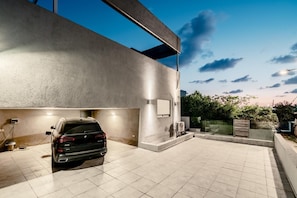 A modern building with a car parked in an outdoor area.