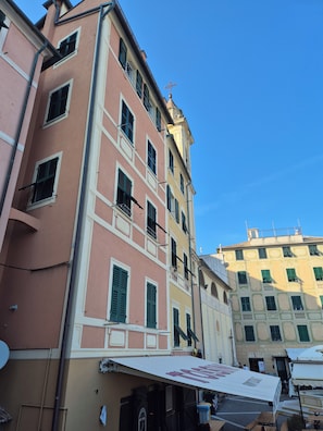 A multi-story building with a flat facade, multiple windows with shutters, and a visible cross on the roof. - Windows on the Sea, an oasis of relaxation in Sori, in the Golfo Paradiso (Sori)