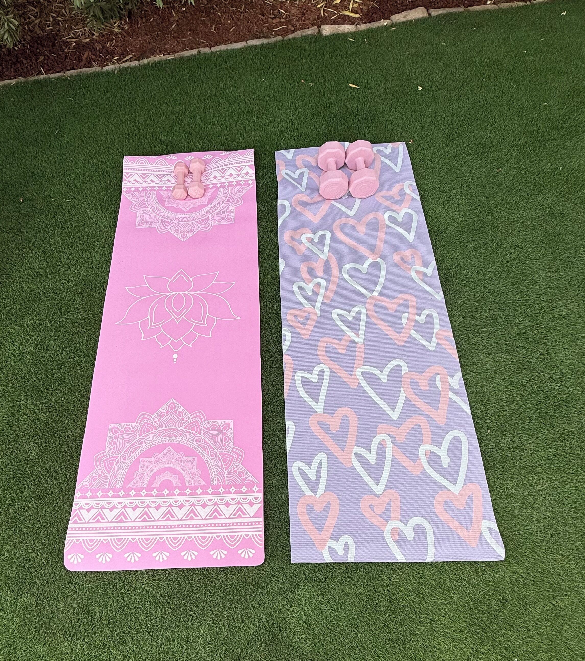 Two yoga mats on artificial grass.