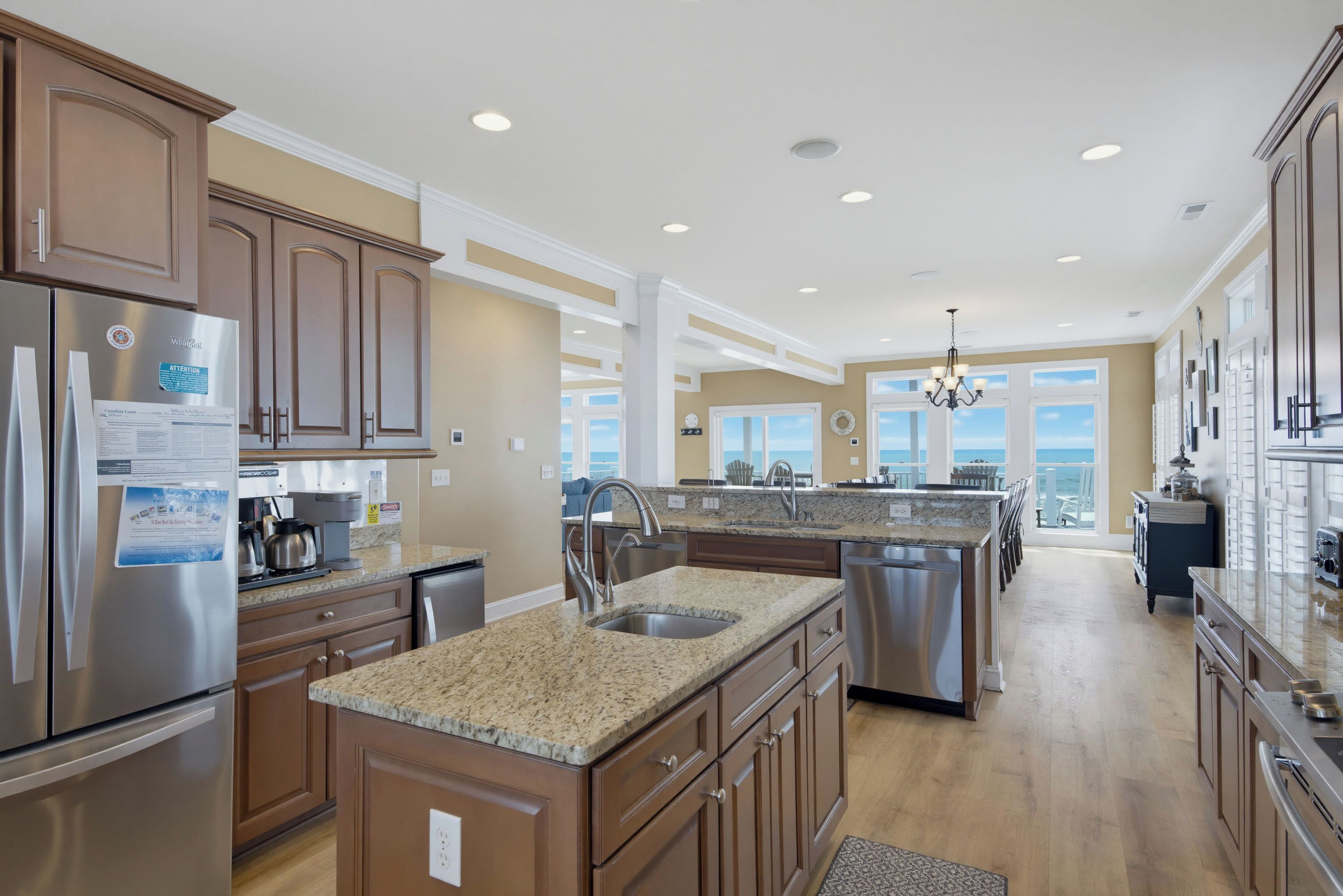A spacious kitchen with granite countertops, stainless steel appliances, and a large island with a sink.