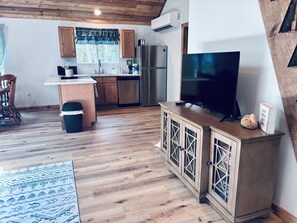A modern kitchen with wooden cabinets, a stainless steel refrigerator, and a built-in dishwasher. - 3 bedroom house in quiet Warsaw neighborhood sitting on Lake of the Ozarks! (Warsaw)