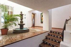 A staircase with a tiled handrail and a potted plant beside it. - Private beachfront villa w/ private pool and chef (Puerto Vallarta)