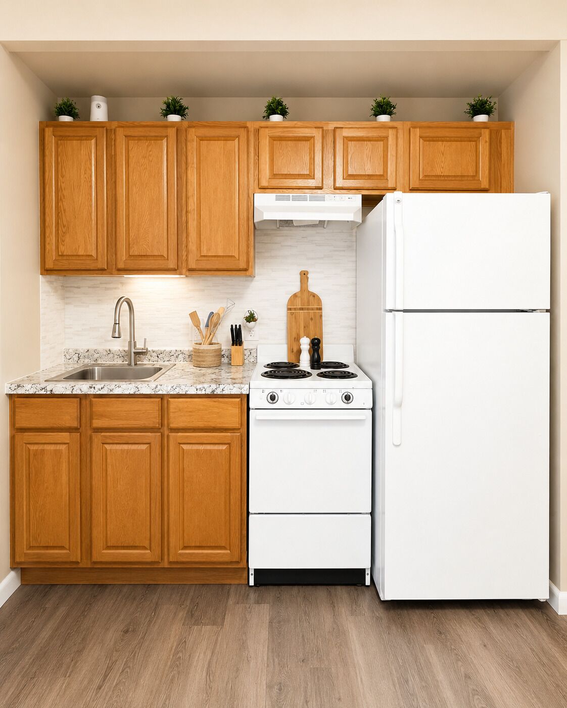 A kitchen with wooden cabinets, a white stove, and a white refrigerator.