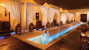 A series of spa-style rooms with individual seating and a central water feature.