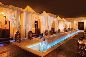 A series of spa-style rooms with individual seating and a central water feature. - All inclusive romantic swim out room with jacuzzi for 2 at Secrets Maroma Beach (Playa del Carmen)
