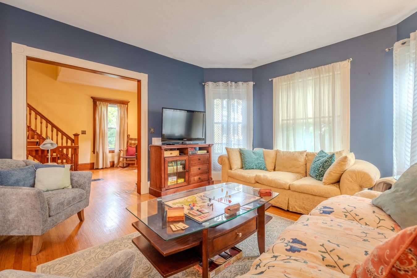 A living room with a sofa, a coffee table, and a television.