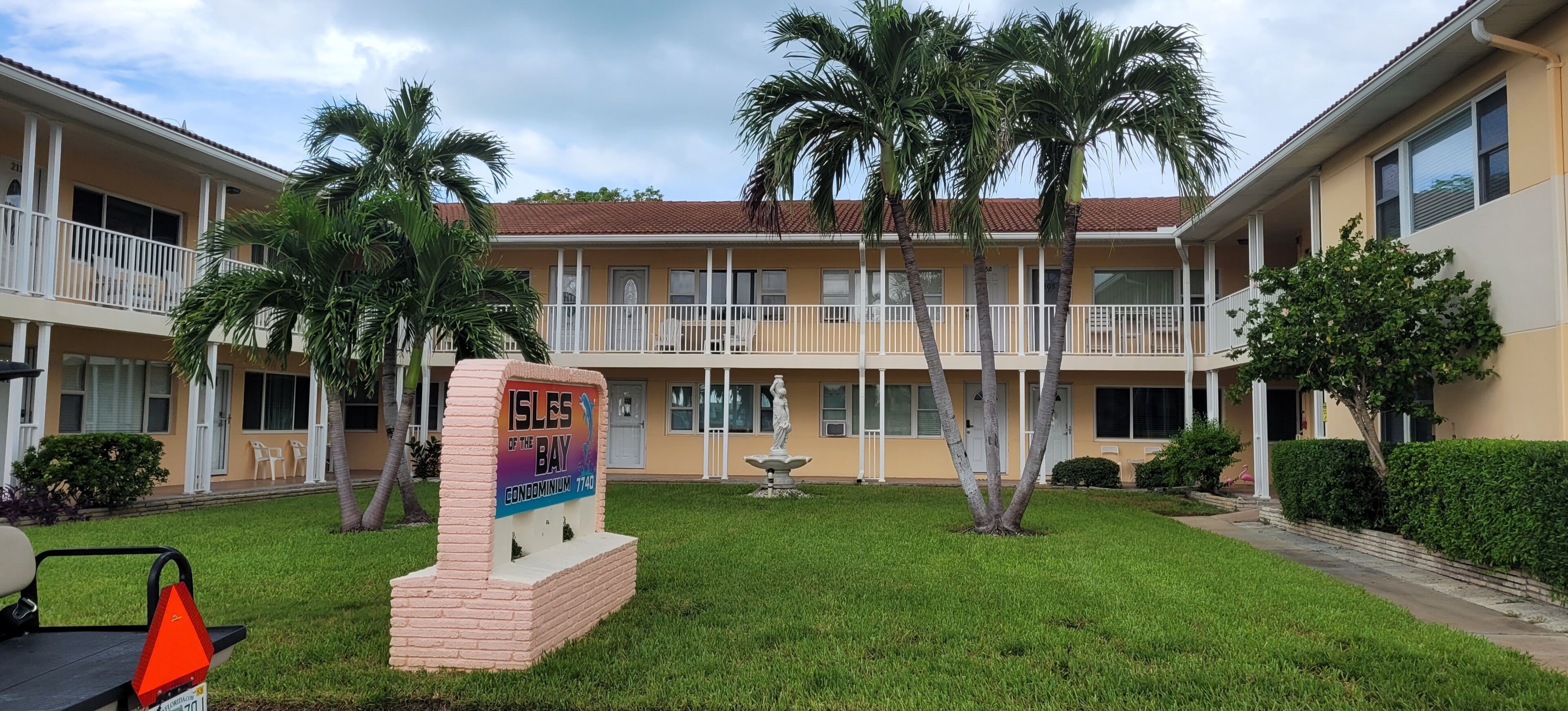 A multi-story building with a sign indicating it's a condominium.