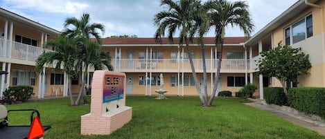 A multi-story building with a sign indicating it's a condominium.
