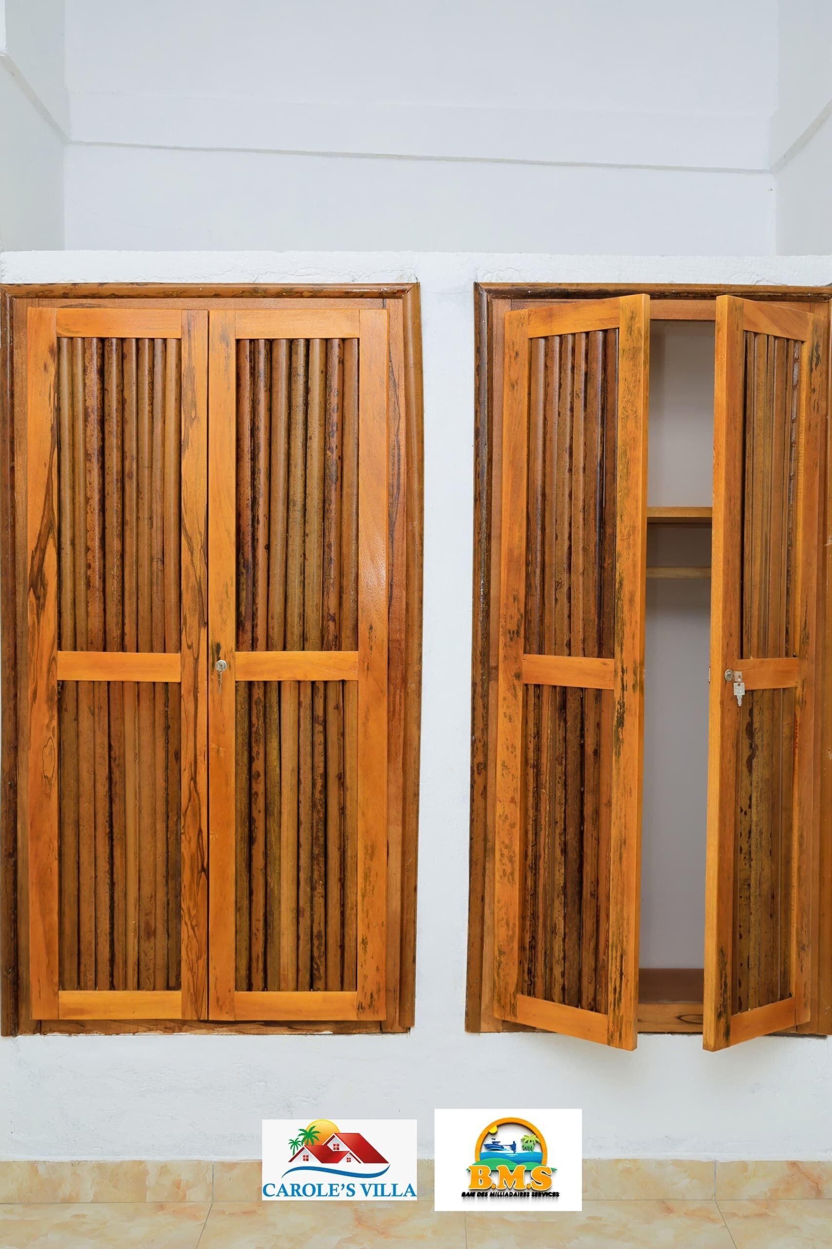 Two wooden doors with vertical slats, one closed and one open revealing a closet.