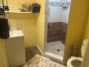 A bathroom with a shower, sink, and toilet. - Your Ideal Stay Near the Stockyards (Fort Worth)