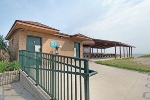 A beachside building with a covered picnic area and a restroom. - Private, serene house 5-min to beach with panoramic views from two decks (Milford)