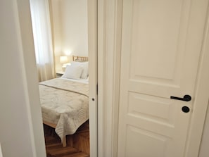 A bedroom with a bed, a nightstand, and a lamp. - #Chic Harbor Old Town Bridge Apartment - TINELINN Apartments Zadar (Zadar)