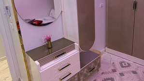 A room with a vanity, a mirror, a wardrobe, and patterned flooring. - Lavonda Beach resort hurghada (Hurghada)