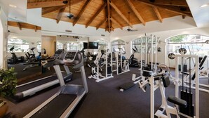 A gym with treadmills, weight machines, and a ceiling with wooden beams. - Hummingbird Hideaway - Executive Resort-style Condo (Phoenix)