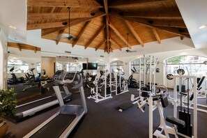 A gym with treadmills, weight machines, and a ceiling with wooden beams. - Hummingbird Hideaway - Executive Resort-style Condo (Phoenix)