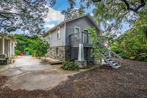A two-story house with a stone foundation, a front porch, and a staircase leading to the entrance. - Riverfront View w/ Kayaks in the midst of Tampa's Best Restaurant District (Tampa)