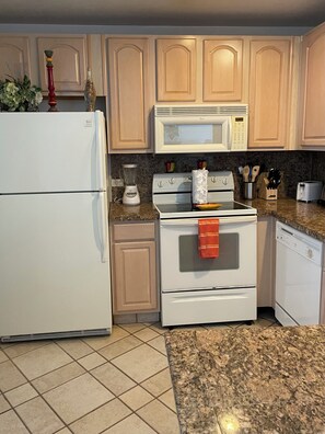 A kitchen with a refrigerator, microwave, stove, and dishwasher. - 1-bedroom Sandy Beach condo with ocean view and AC (Puerto Peñasco)