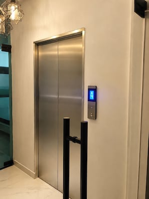An elevator with a digital display and a modern design. - Ocean View, 5 min drive to Beach, Hot Water, Elevator, 24/7 Power. (La Romana)
