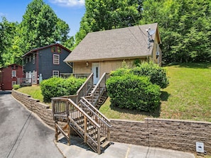 A two-story house with a front porch and a satellite dish. - Sleeps 4, Romantic Chalet, Private Hot Tub, Jacuzzi Tub, Gas Fireplace (Gatlinburg)