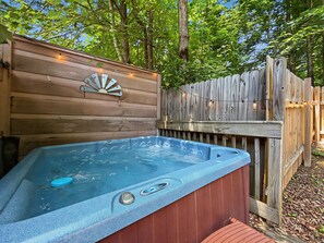 A hot tub with a wooden deck and a wooden fence in the background. - Sleeps 4, Romantic Chalet, Private Hot Tub, Jacuzzi Tub, Gas Fireplace (Gatlinburg)