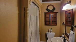 A bathroom with a toilet, sink, and vanity.