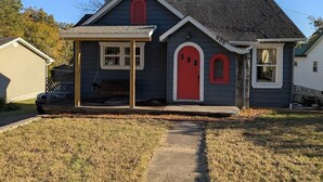 A residential house with a red door, a small porch, and a visible address number. - Gingerbread Home | Quiet Stay | 30+ Day Ready (Chattanooga)