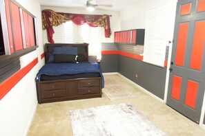 A bedroom with a bed, a nightstand, a dresser, a window with blinds, and a door. - Spacious 4-Bedroom House /Self Check-In/Wifi/King Bed/EV Charger/Newly Renovated (Modesto)