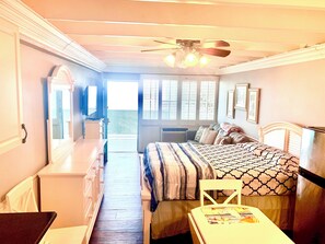 A bedroom with a bed, a desk, a chair, a ceiling fan, and a window. - #425 Fontainebleau Updated Beachfront Condo (Panama City Beach)