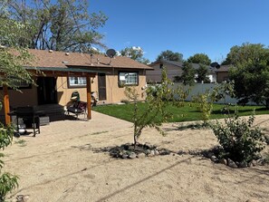 A residential property with a patio area, outdoor furniture, and a small garden. - 7-Min Down Town Reno & UNR 35 Min to MtRoseSki & Walking Distance to the Rodeo. (Reno)