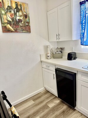A kitchen with white cabinets, a dishwasher, a toaster, and a coffee maker. - 7-Min Down Town Reno & UNR 35 Min to MtRoseSki & Walking Distance to the Rodeo. (Reno)