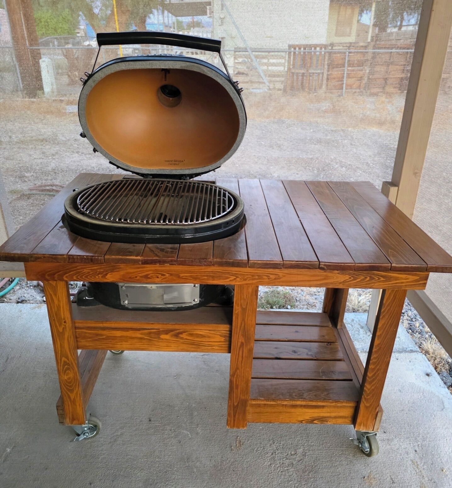 A wooden table with a grill on top.